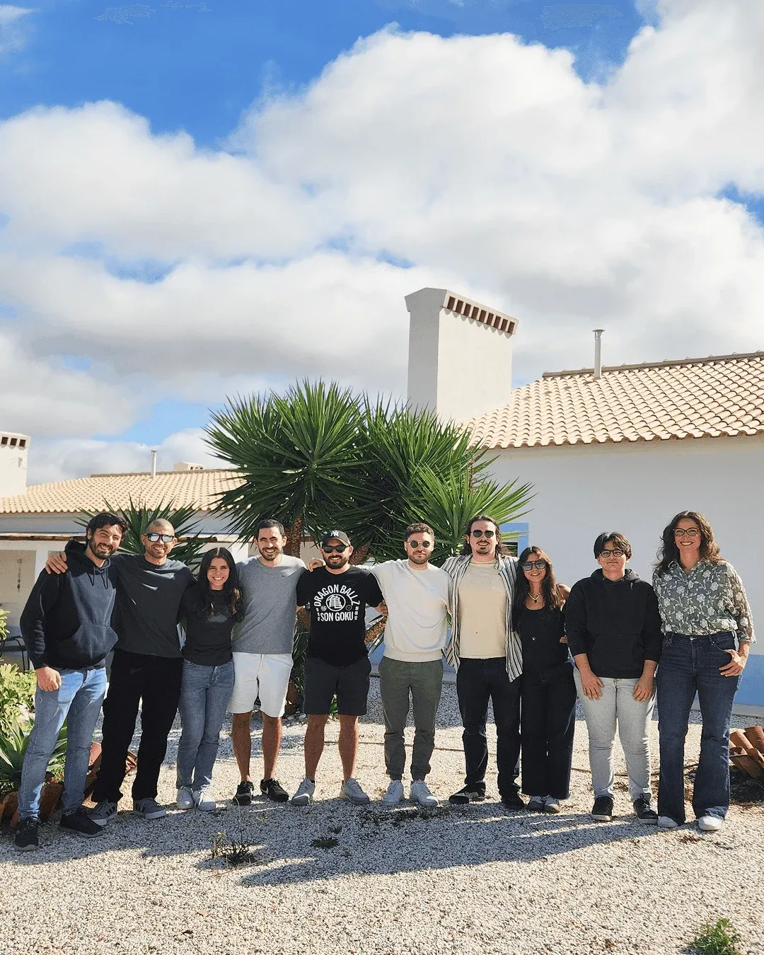 Concealed team photo with all ten members smiling and looking at the camera.